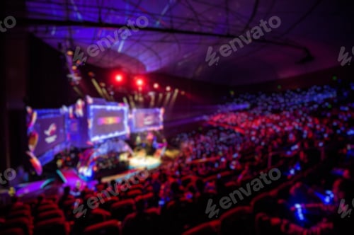 Preview: Blurred background of esports event at big arena with a lot of lights and screens
