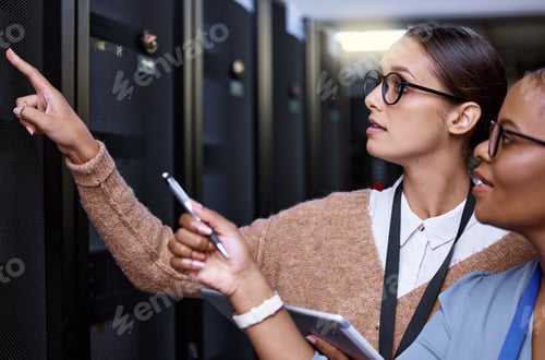 Preview: Cropped shot of two attractive young female computer programmers working together in a server room