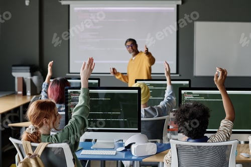Preview: Teenagers Raising Hands During Coding Lesson