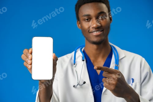 Preview: Cheerful african doctor using mobile phone over blue studio background