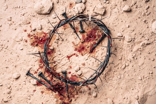 Preview: Crown of thorns, bloody nails on sand background. Good Friday, Passion of Jesus Christ. Christian