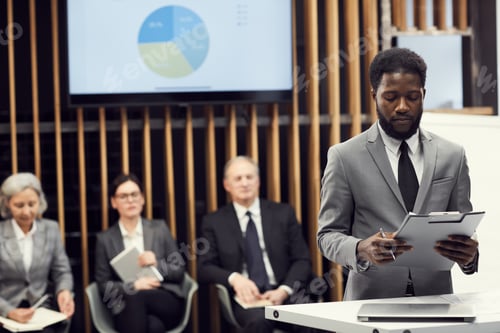 Preview: Young businessman preparing for public speech