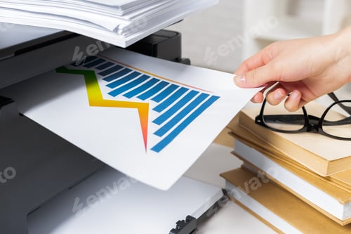 Preview: Printing a report with a colorful chart at a workspace desk with documents