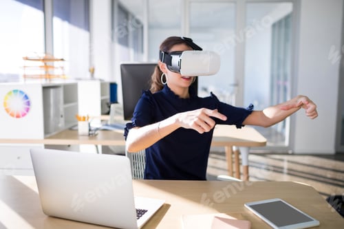 Preview: Female executive using virtual reality headset