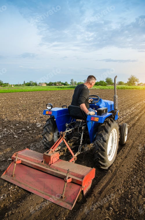 Preview: A farmer is cultivating a field before replanting seedlings.
