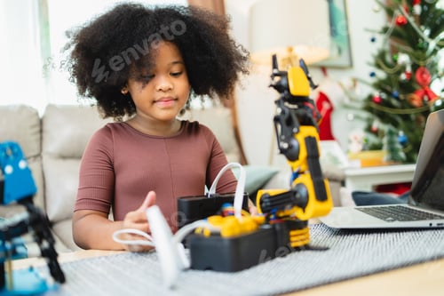 Preview: Two African American girls learned robot arms with a program computer.