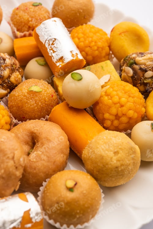Preview: Group of Indian assorted sweets or mithai with diya