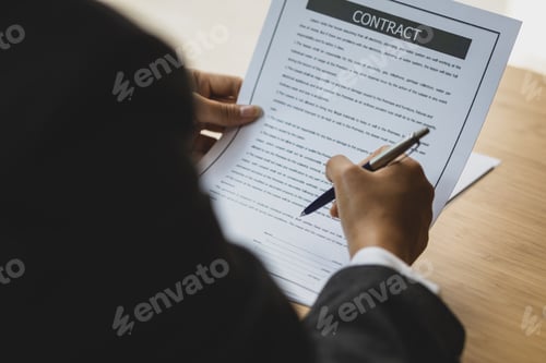 Preview: Female lawyer working in the office reading documents and signing legal agreement contracts.