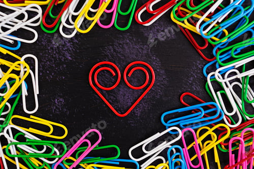 Preview: Colored paper clips isolated on dark background