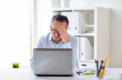 Preview: businessman in eyeglasses with laptop at office