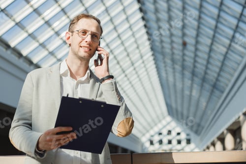 Preview: Professional Man Talking on Phone in Business Setting