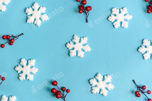 Preview: Creative pattern banner with snow flakes nad red berries on pastel blue background.