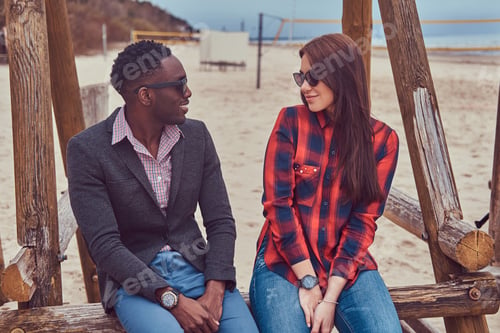Preview: Attractive couple on the beach. African-American guy and Caucasi