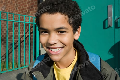 Preview: Smiling teenager enjoying the sunshine outside school