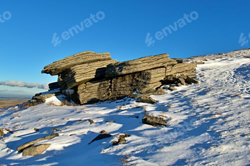 Preview: Large rock formation standing on the Yes Tor peak with an idyllic winter landscape in background