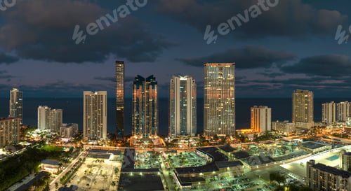 Preview: View from above of brightly illuminated high skyscraper buildings in downtown
