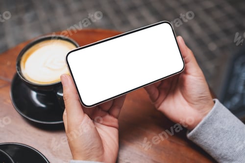 Preview: Mockup image of a woman holding mobile phone with blank desktop screen