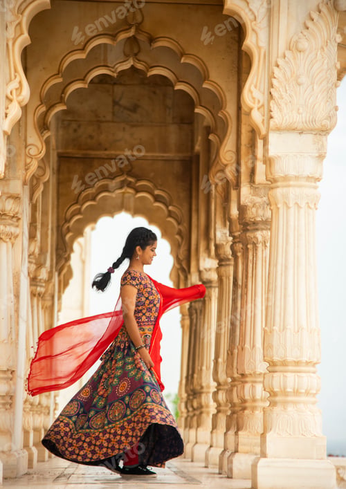 Preview: Young female tourist dancing between arches and Pillars.