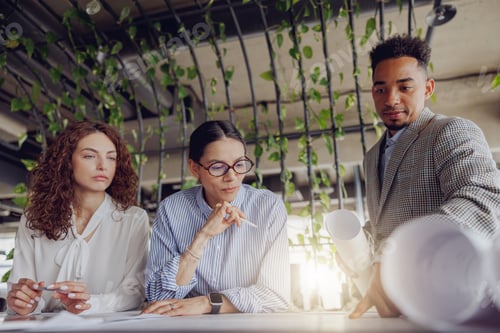 Preview: A Collaborative Business Meeting Taking Place in a Modern and Vibrant Office Space Environment