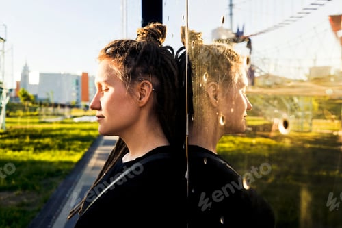 Preview: Young happy woman with dreadlocks in park