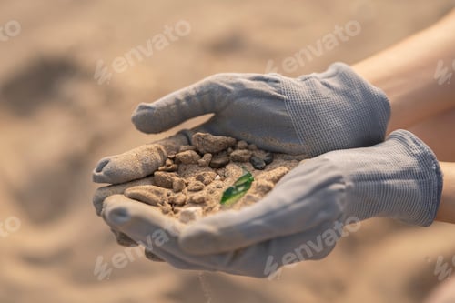 Preview: Holding sand mixed with microplastic waste on a beach