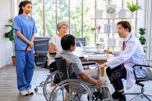 Preview: Senior couple male on wheel chair having consultations with doctor for knee problems at clinic