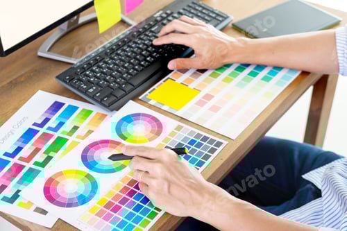 Graphic designer or creative holding Mouse and do his work material color pantone swatch samples art