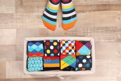 Preview: Woman with different socks standing on floor, top view