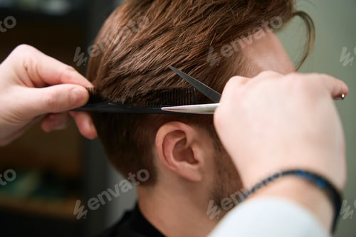 Preview: Barber making haircut to his client in room