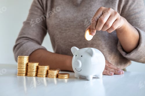Preview: Young woman putting coins into piggy bank planning growing saving to strategy with money box for
