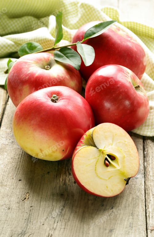 Preview: organic red apples on wooden table