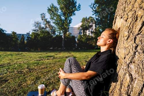 Preview: Mindful pause outdoors with urban woman in city park.