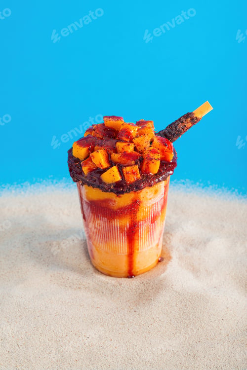 Preview: Mangonada, typical mexican mango smoothie on summer background.