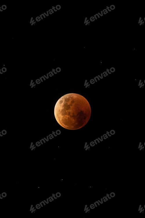 Preview: Vertical shot of a red full moon isolated on the black background in the starry sky