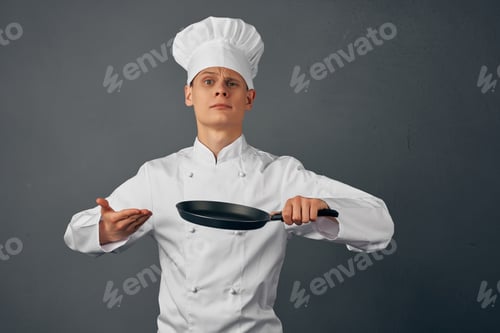 Preview: Cheerful chef in uniform frying pan in hands of restaurant cooking