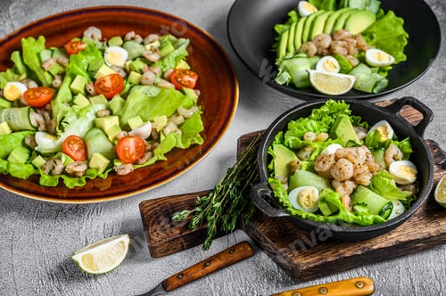Preview: Set of salads with avocado, prawns, shrimps and greens in bowls. White background. top view