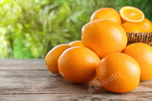 Preview: Fresh juicy oranges on wooden table. Space for text