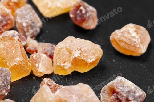 Preview: brown sugar rock organic crystalline close up on dark background