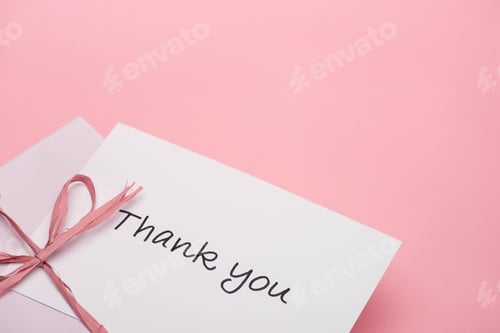 Preview: pink bow near thank you greeting card on pink background