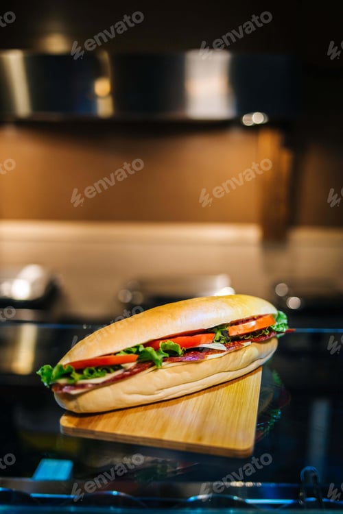 Preview: Vertical shot of a sandwich with tomatoes and sausages