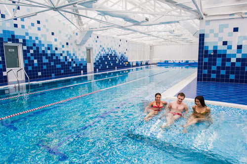 Preview: Joyful friends relaxing in swimming pool