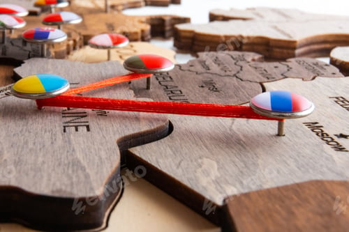 Preview: Pins with flags and threads on the wooden maps demonstrate Russia and Belarus aggression in Ukraine