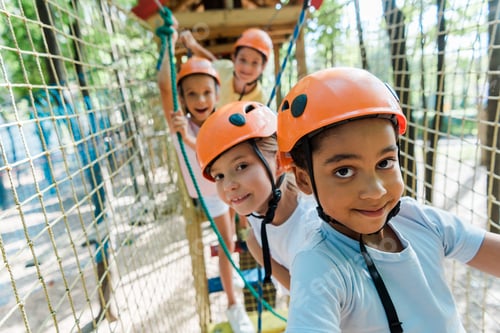 Preview: selective focus of cheerful african american boy near happy friends in helmets