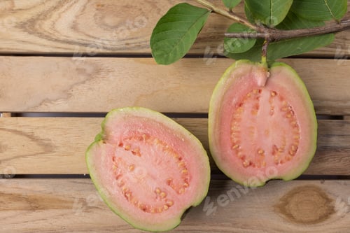 Preview: Guava red fruit cut in half fresh on wood background.