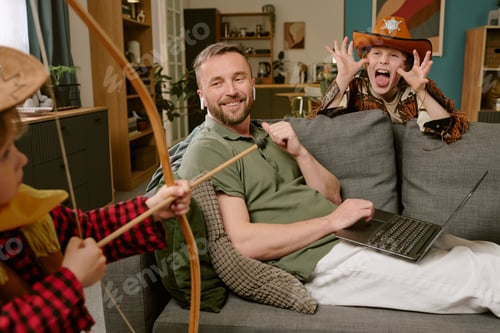 Preview: Young Father Working Remotely While Children Playing Around Him