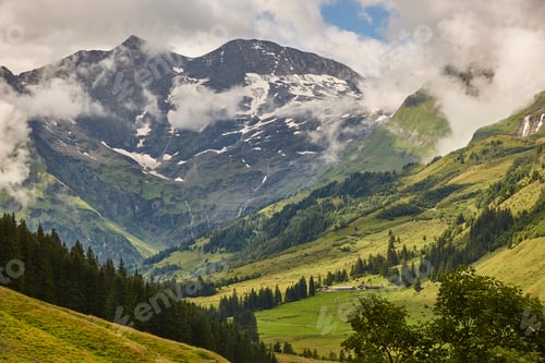 Preview: Grossglockner. Serpentine alpine road viewpoint. Green forest and waterfall. Austria