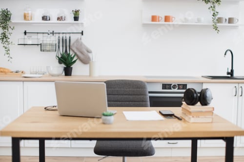 Preview: Distant workplace with gadgets on desk in kitchen interior