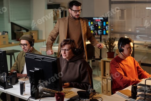 Preview: Multiethnic Young Adults Working at Scam Call Center under Supervisor Guidance