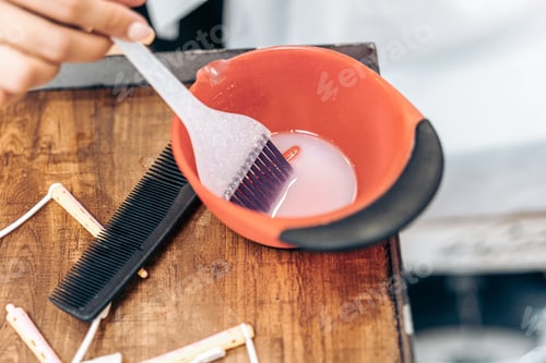 Preview: Plastic brush in a bowl of hair dye in a hairdresser's shop