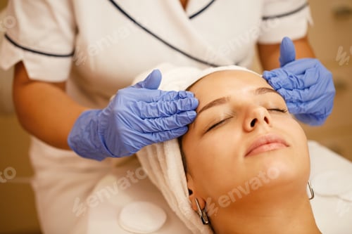 Preview: Close-up of young woman enjoying in head massage at the spa.
